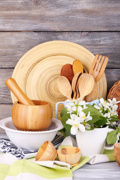 Composition of wooden cutlery, mortar, bowl and cutting board