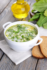 Delicious green soup with sorrel on table close-up