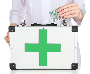 Nurse holding first aid kit, isolated on white