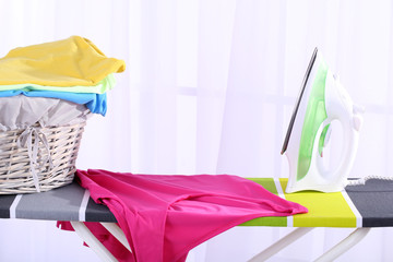 Baskets with laundry and ironing board