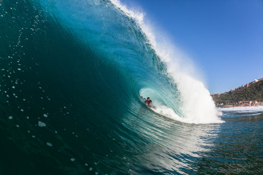 Surfing Rider Inside Large Hollow Blue Wave