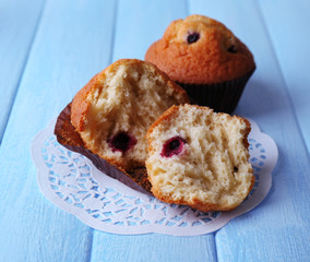 Blueberry muffins on color wooden background