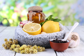 Folk remedies for colds on table on natural background