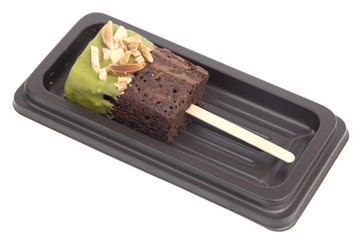 Chocolate cake with green tea coated on stick .