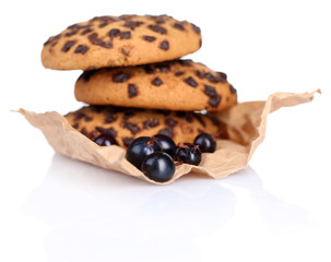 Black currants and cookies isolated on white