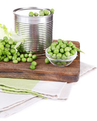 Fresh peas and tin on wooden board, isolated on white