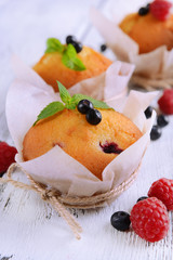 Tasty cupcakes with fruits on table close-up