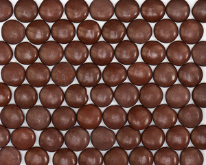 Dark brown dragee in chocolate covered.