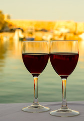 Wine glasses on the table with sea background
