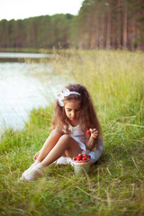 Fototapeta premium Happy beautiful little girl in white dress on grass background w