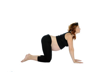 Schwangere Frau macht eine yoga pose