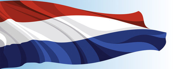 The national flag of the Netherlands on a background of blue sky