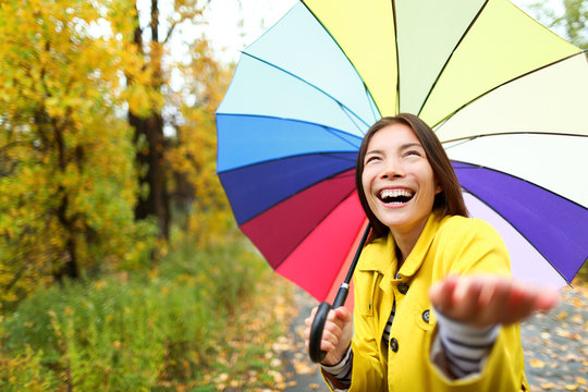 Umbrella woman in Autumn excited under rain
