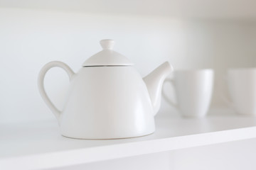 teapot and cups on the shelf
