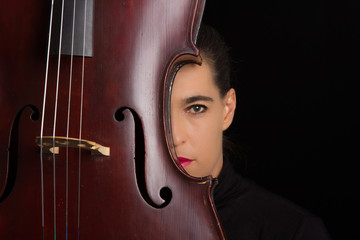 Beautiful brunette holding cello with selective light in black d © Alta Oosthuizen