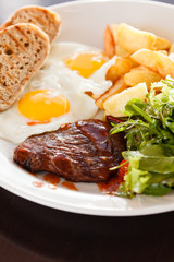 steak with eggs and vegetables