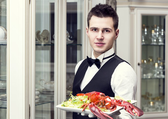 Fototapeta na wymiar waiter with a tray of food in the restaurant hall