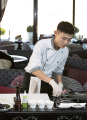 Japanese chef preparing a meal in a restaurant