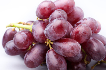 Bunch of red grapes, close-up on a white background