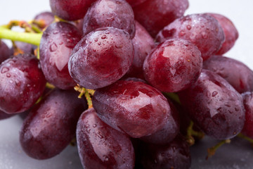 Bunch of red grapes, close-up, with droplets of water