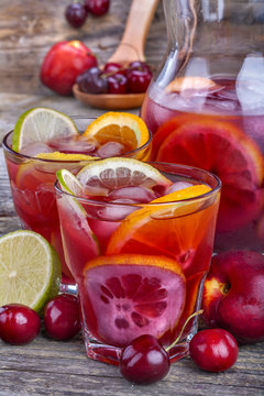 ice refreshing summer drink with lots of different fruits
