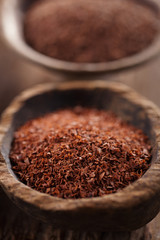 fine grated chocolate in old wooden spoon