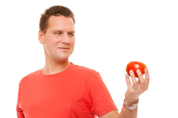 Happy man in red shirt holding apple. Diet health 