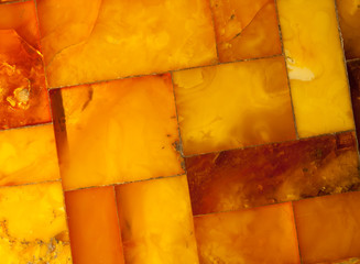 Closeup of golden amber mosaic as background or texture. Gem.