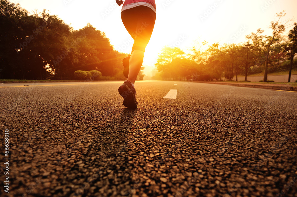 Poster healthy lifestyle young woman legs running on sunrise road