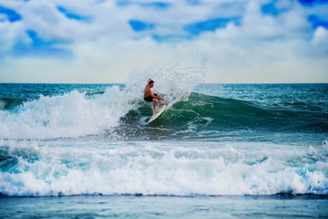 Athletic surfer with board
