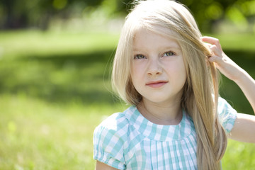 Portrait of a beautiful blonde little girl three years