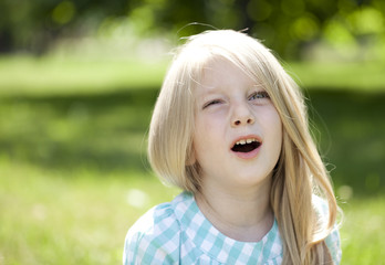 Portrait of a beautiful blonde little girl three years