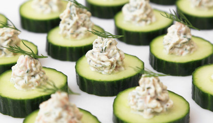 Salmon mousse served on cucumber slices, garnished with dill