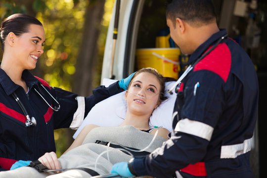 paramedics talking to patient on stretcher