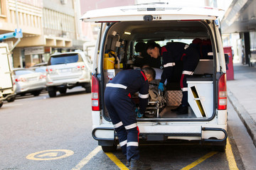 paramedics offloading patient from ambulance