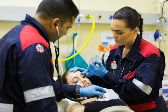 paramedics examining patient