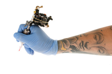Tattoo artist at work isolated on white. Closeup