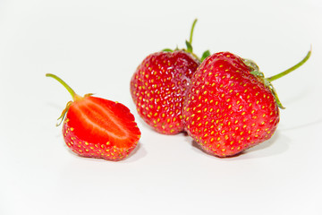 Heart-shaped strawberries on a white background .