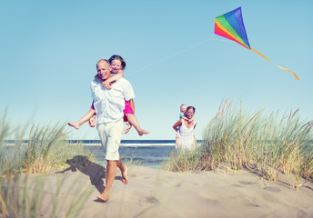 Cheerful Family Playing by the Beach