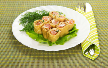 Pancakes with salmon and salad, cutlery