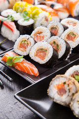 Delicious sushi pieces served on black stone