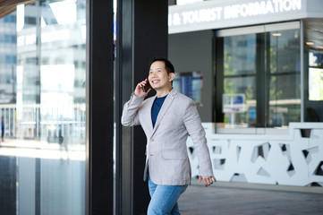 Man exiting building with mobile phone