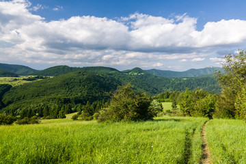 Obraz premium Amazing summer mountain countryside with blue sky and clouds