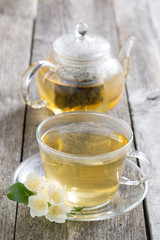 kettle and a cup of green tea with jasmine
