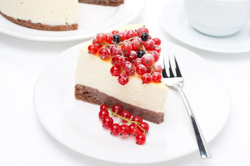 piece of cheesecake with red and black currants and coffee