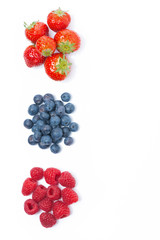 raspberries, blueberries and strawberries, top view, isolated