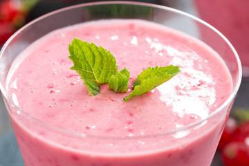 refreshing milkshake with fresh berries and mint, closeup