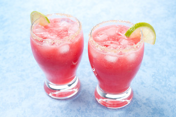 Two glasses of watermelon cocktail with brown sugar and lime