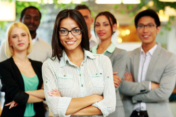 Smiling businesswoman with arms folded 