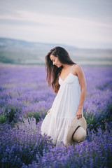 Beautiful young woman posing in a lavender field